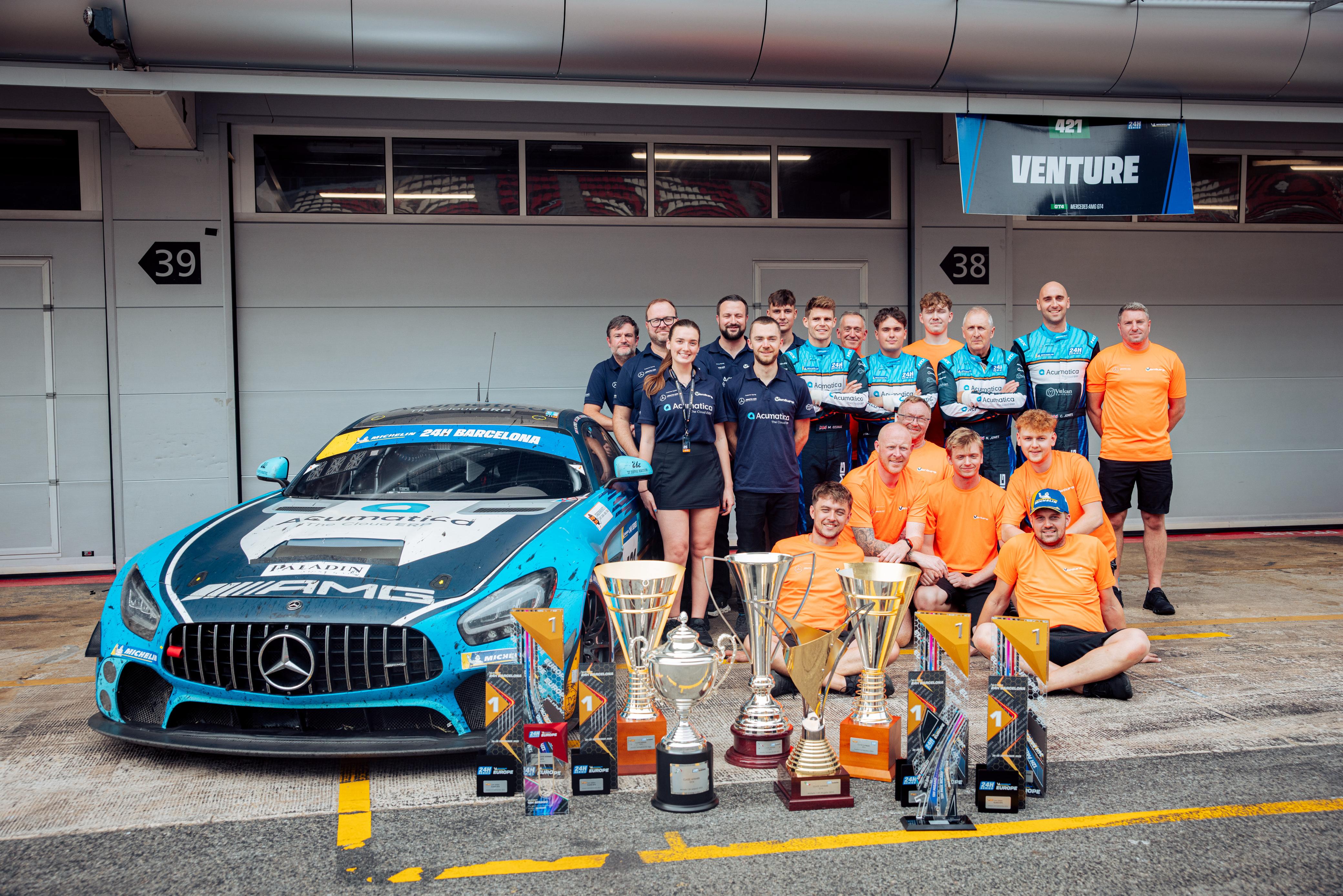 Owen Hizzey celebrating with his endurance racing team and trophies