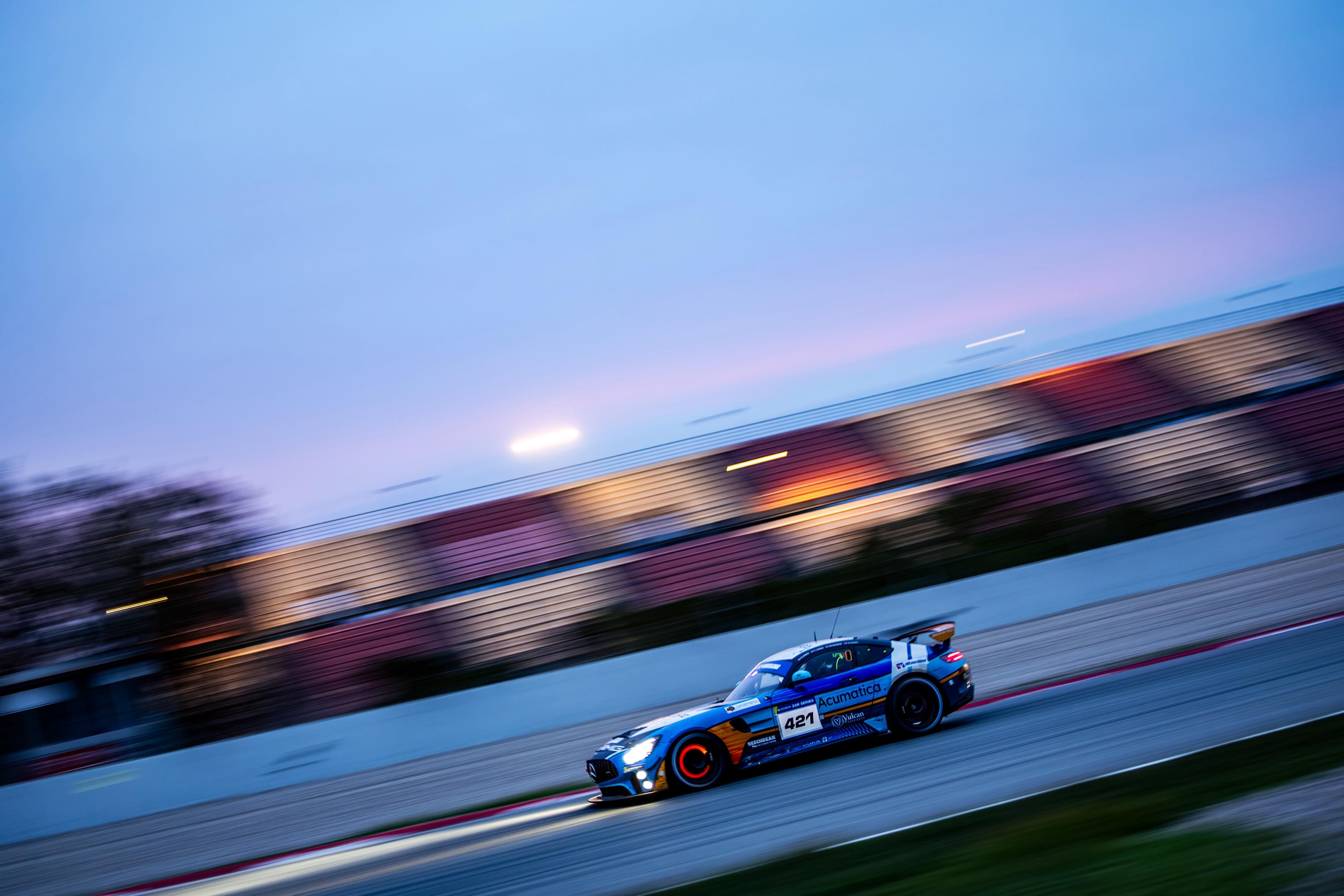 The blue Mercedes-AMG GT4 racing at speed