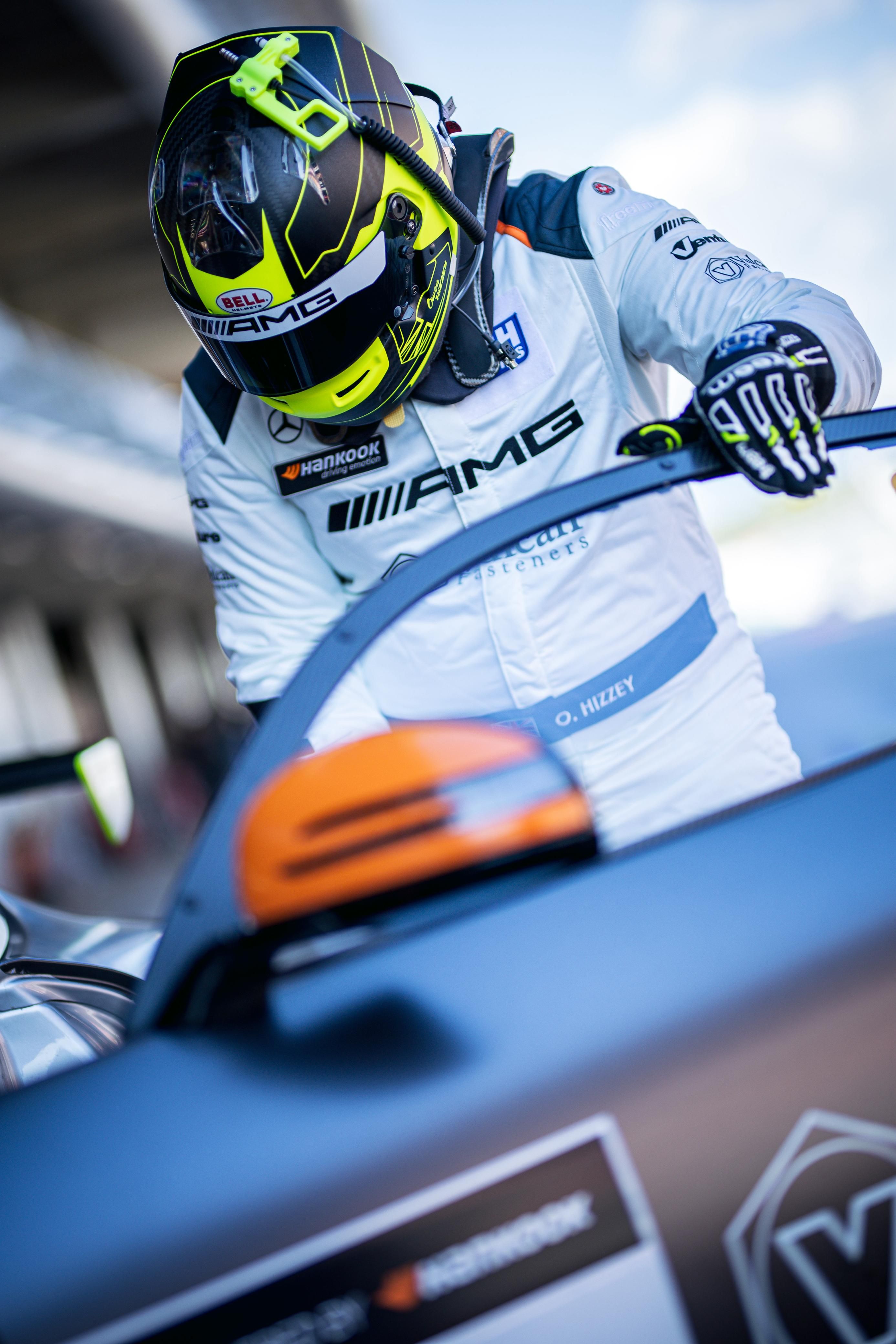 Owen Hizzey entering the Mercedes-AMG wearing his racing helmet