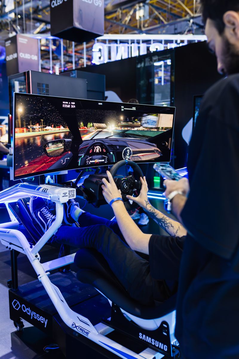 A professional racing simulator with a curved display, wheel and fixed cockpit